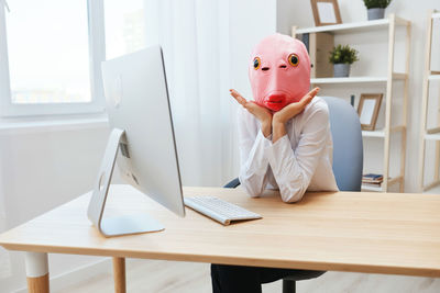 Young woman using laptop at table