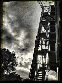 Low angle view of building against cloudy sky