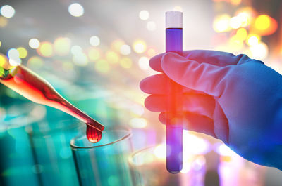 Cropped hand of scientist testing chemicals in laboratory