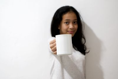 Portrait of smiling man holding coffee cup