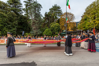 People in uniforms and traditional clothing during festival