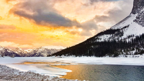 Scenic view of snowcapped mountains against sky during sunset