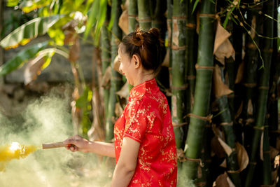 Side view of woman standing outdoors