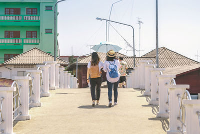 Full length of women walking on built structure