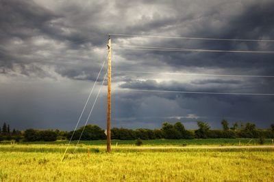 Windmill on field against sky