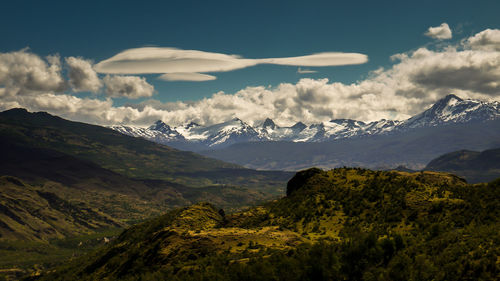 Scenic view of mountains against cloudy sky