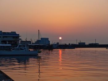 Sailboats in marina at sunset