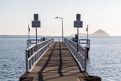 Pier over sea against clear sky