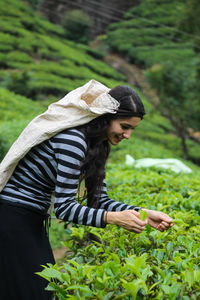 Woman standing by plants