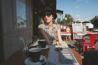 Portrait of young woman sitting on bench