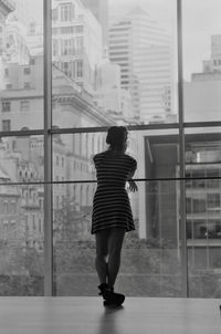 Rear view of woman standing in city