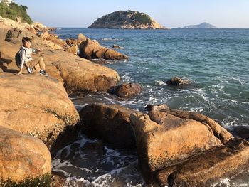 Rocks on beach against sky