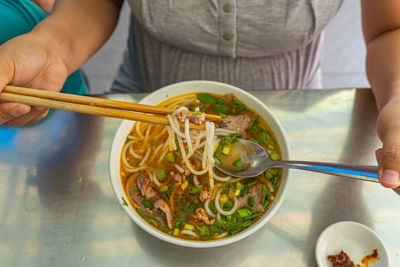 Midsection of man having food in bowl