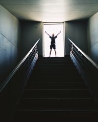 Low angle view of silhouette person standing on staircase