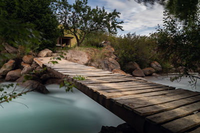 Scenic view of swimming pool by lake against sky