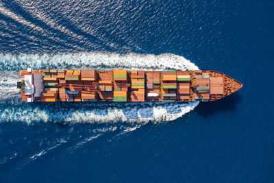 Directly above shot of container ship sailing in sea