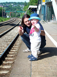 Portrait of a smiling boy on railroad tracks