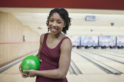 A young woman with a bowling ball.