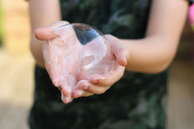 Cropped hand of man holding crystal ball