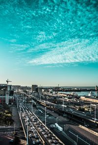 High angle view of cityscape by sea against sky