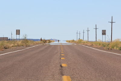 Empty road along trees