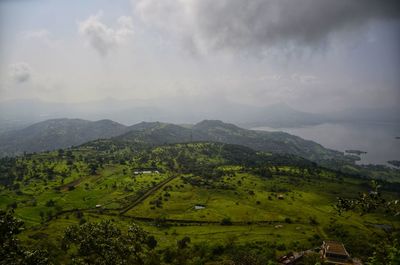 High angle view of green landscape against sky