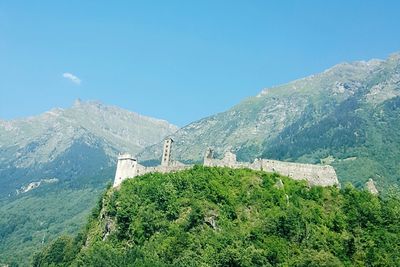 Scenic view of mountains against cloudy sky