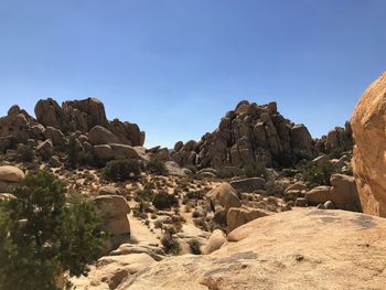 Rock formations on landscape against clear sky