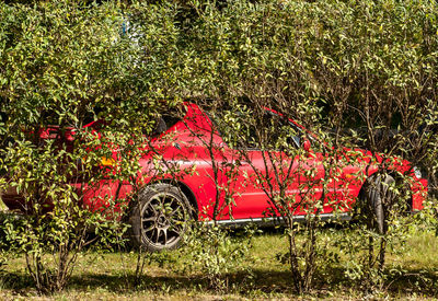 View of abandoned car on field