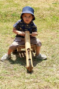 Full length of boy sitting on grass