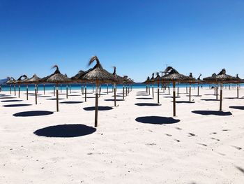 Built structure on beach against clear blue sky