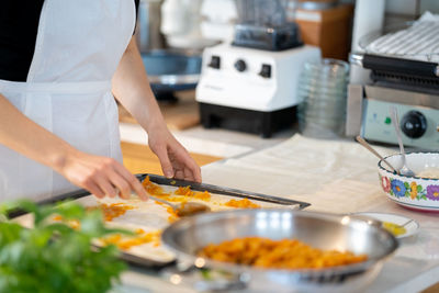 Midsection of man preparing food at restaurant