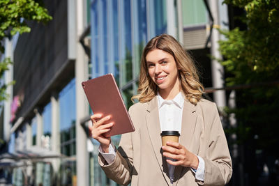 Portrait of young woman using digital tablet