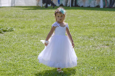 Girl standing on grassy field