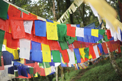 Close-up of multi colored prayer flags hanging outdoors