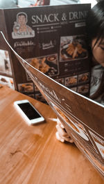Close-up of woman using laptop on table