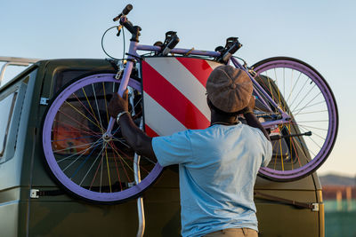 African american man with an old-fashioned bicycle in his van