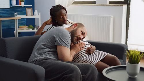 Husband listening baby in mothers belly