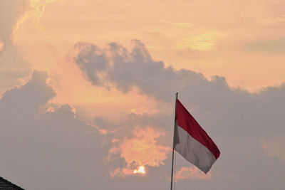 Low angle view of flag against sky during sunset