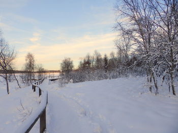 Snow covered landscape against sky