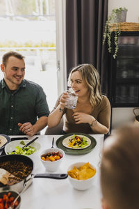 Group of friends eating mexican food at home