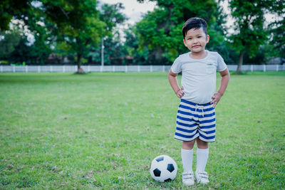 Full length of girl holding ball on field