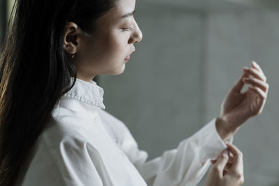 Portrait of young woman looking at camera