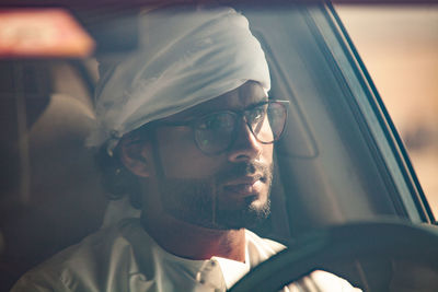 Portrait of man seen through car window