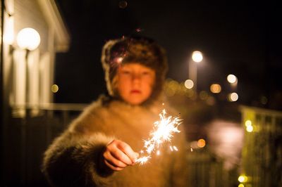 Portrait of a child holding sparkler