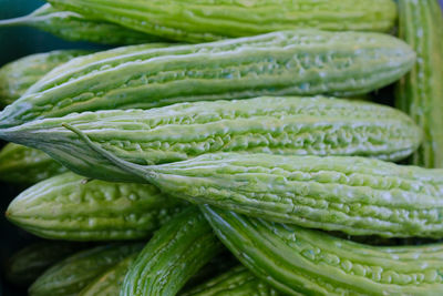 Close-up of green chili peppers for sale at market stall