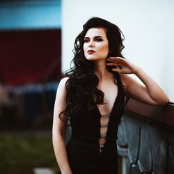 Portrait of beautiful young woman standing outdoors