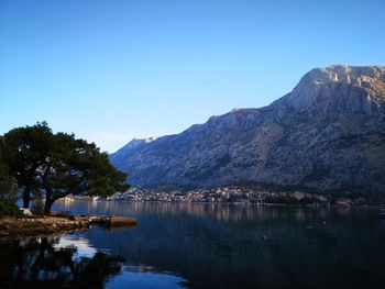 Scenic view of lake and mountains against clear sky