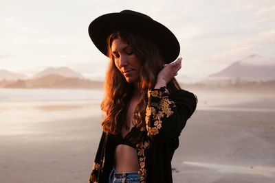 Beautiful, stylish woman on cox bay beach in tofino