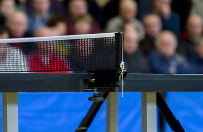 Table tennis net against spectators